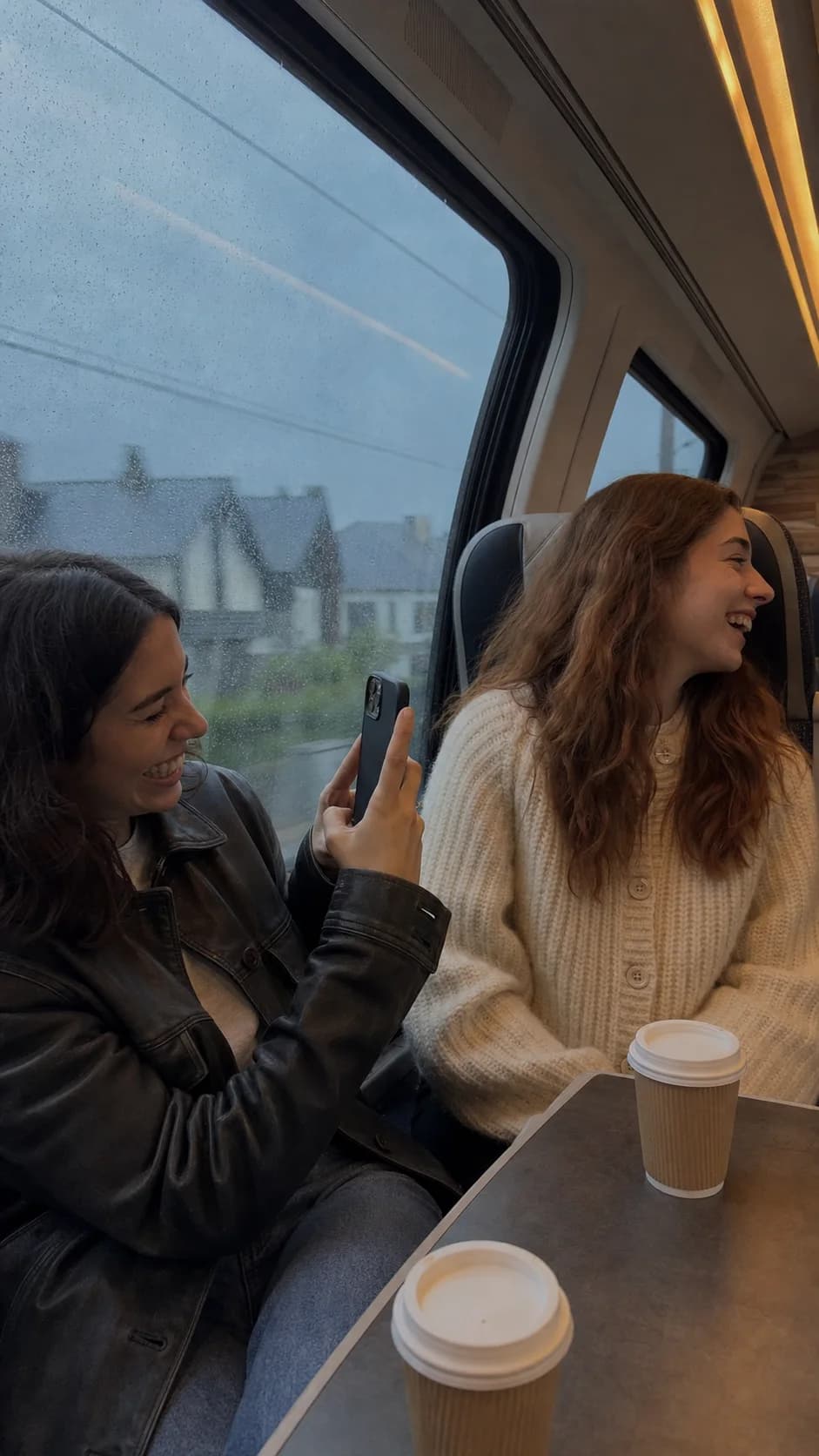 The same two friends sharing coffee on the morning train