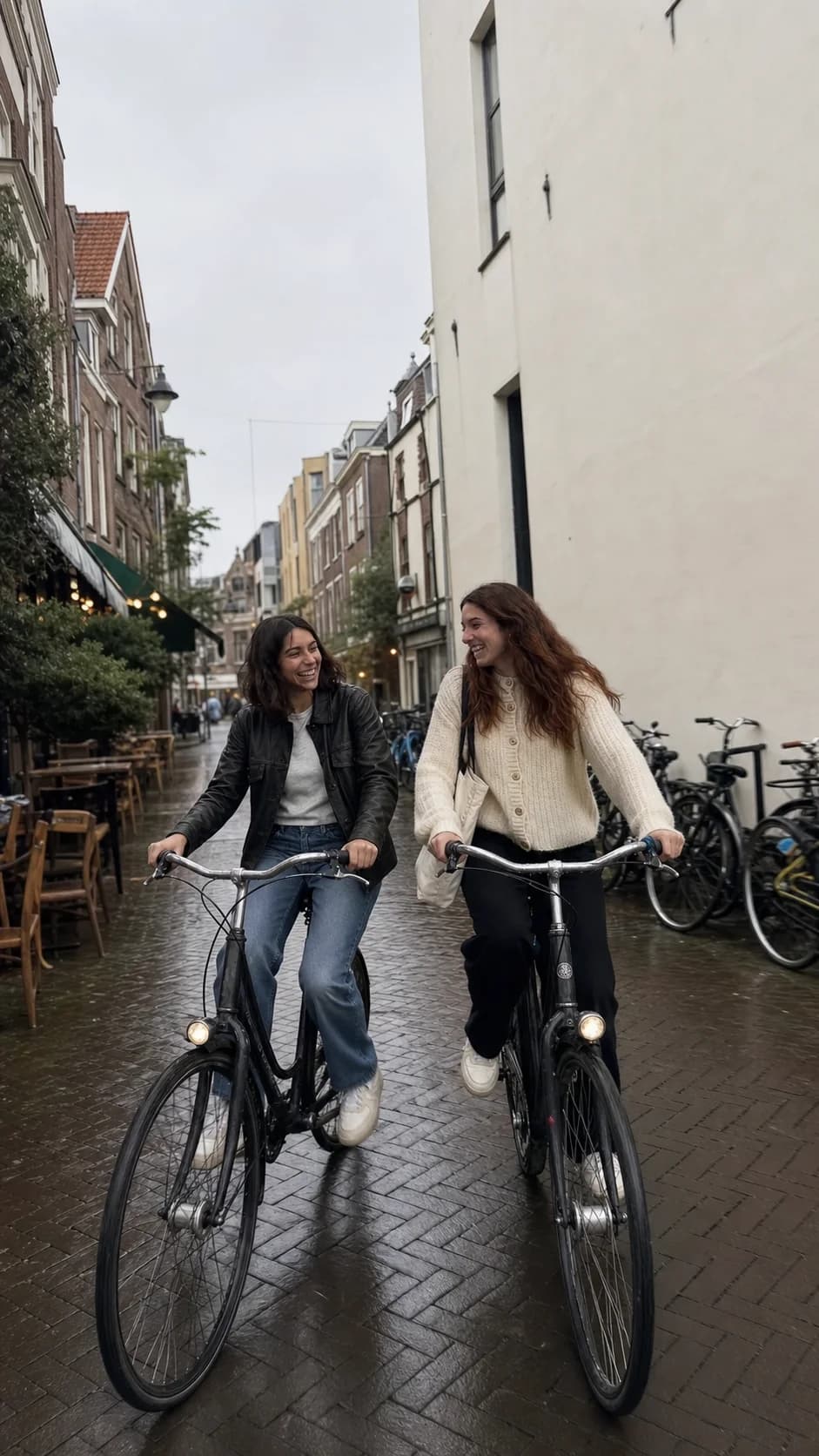 The same friends riding city bikes down a wet street